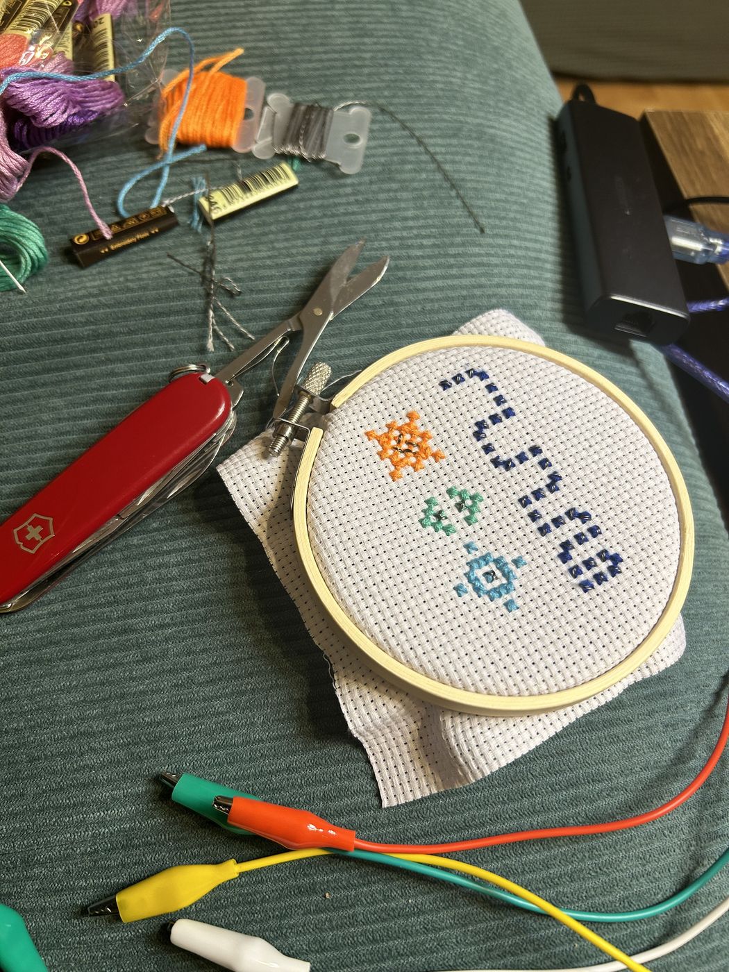 Cross-stitched hoop connected with alligator-clip leads