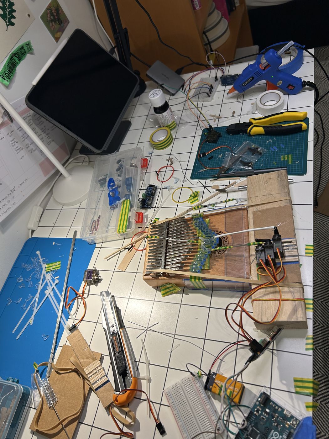 Laser-cut parts and tools laid out on the desk