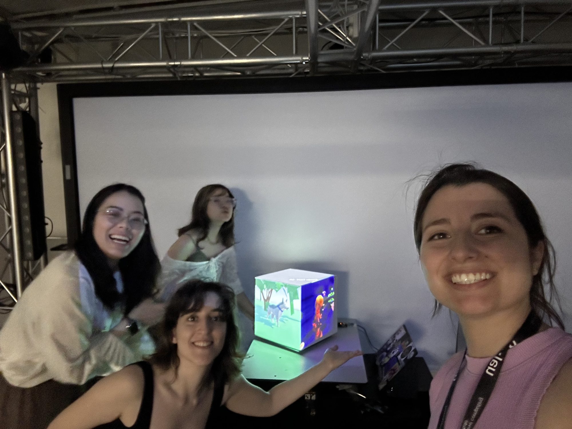 The team with the glowing cube at the exhibition